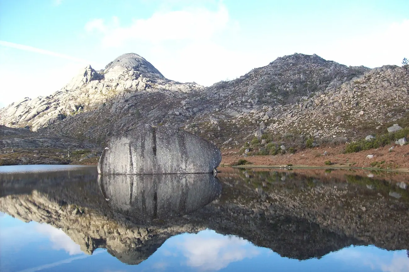 Granite mountains reflected in the still water of Lagoa da Peneda in Peneda-Gerês National Park