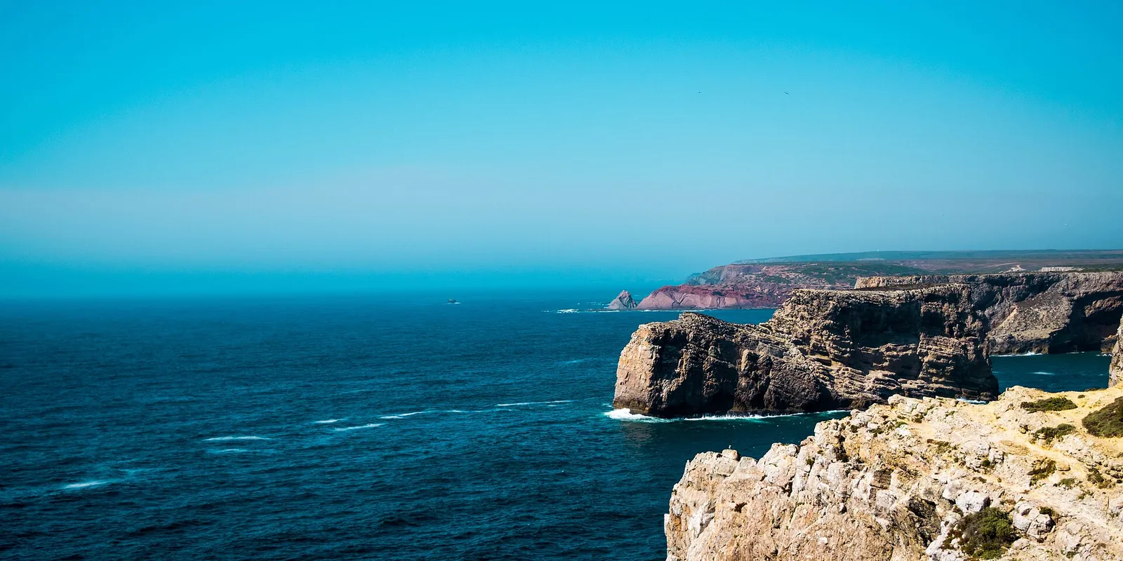 Golden limestone cliffs at Cape St. Vincent near Sagres above a deep blue Atlantic